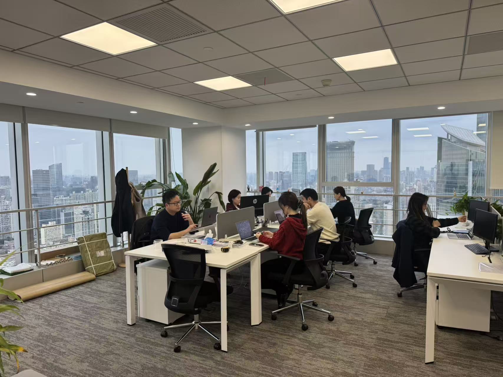 SIMI Rail team working in the Shanghai office with city skyline views